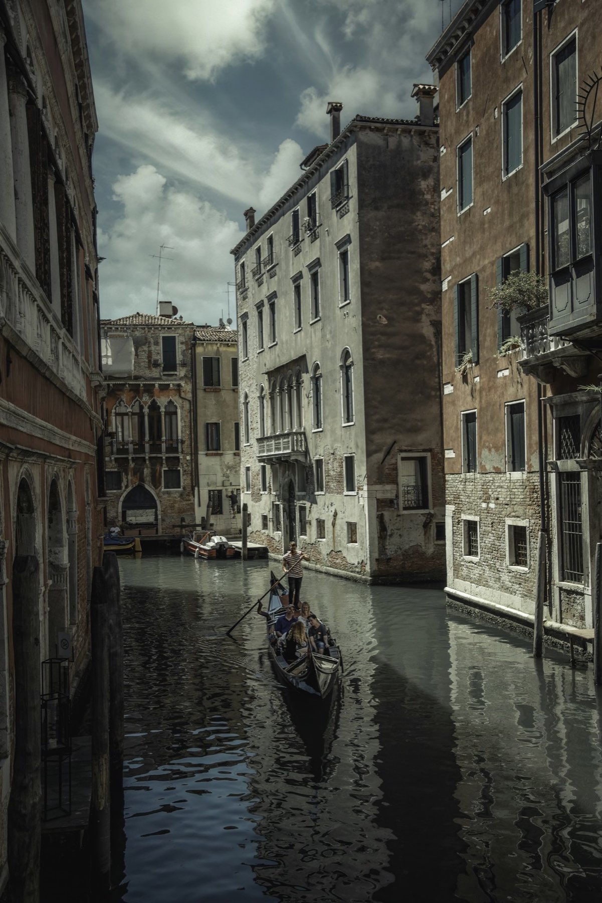 An intimate view from a gondola along a quiet Venetian canal